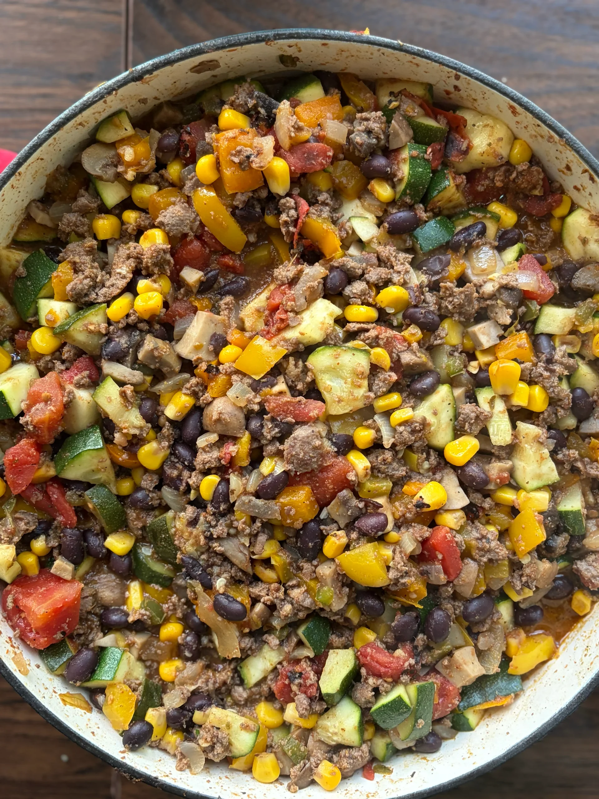 Ground beef, tomatoes, bell peppers, and zucchini all mixed together in a skillet with seasonings. 