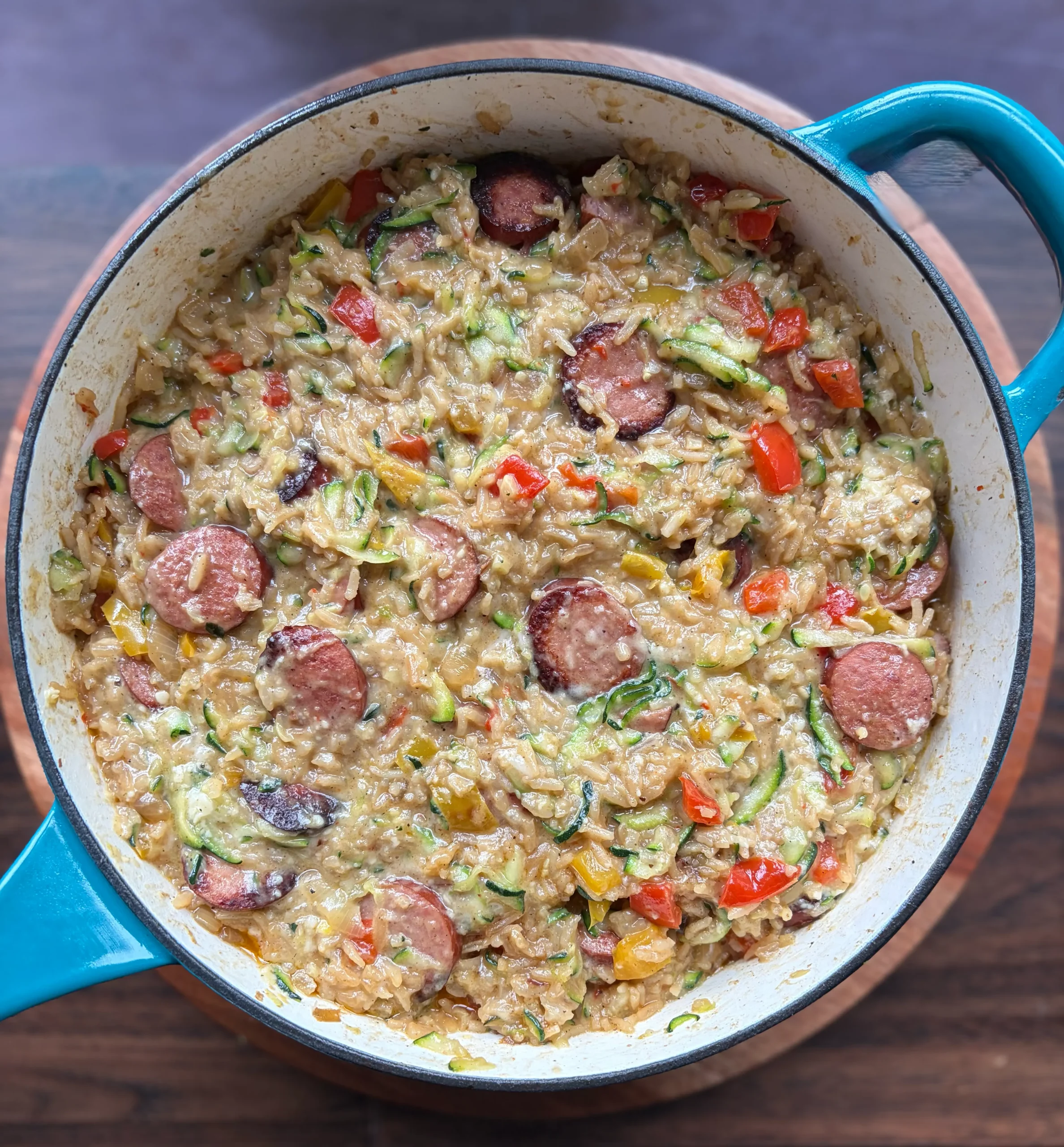 Sausage rice and zucchini in a skillet. Cooking with cheese and bell peppers.  