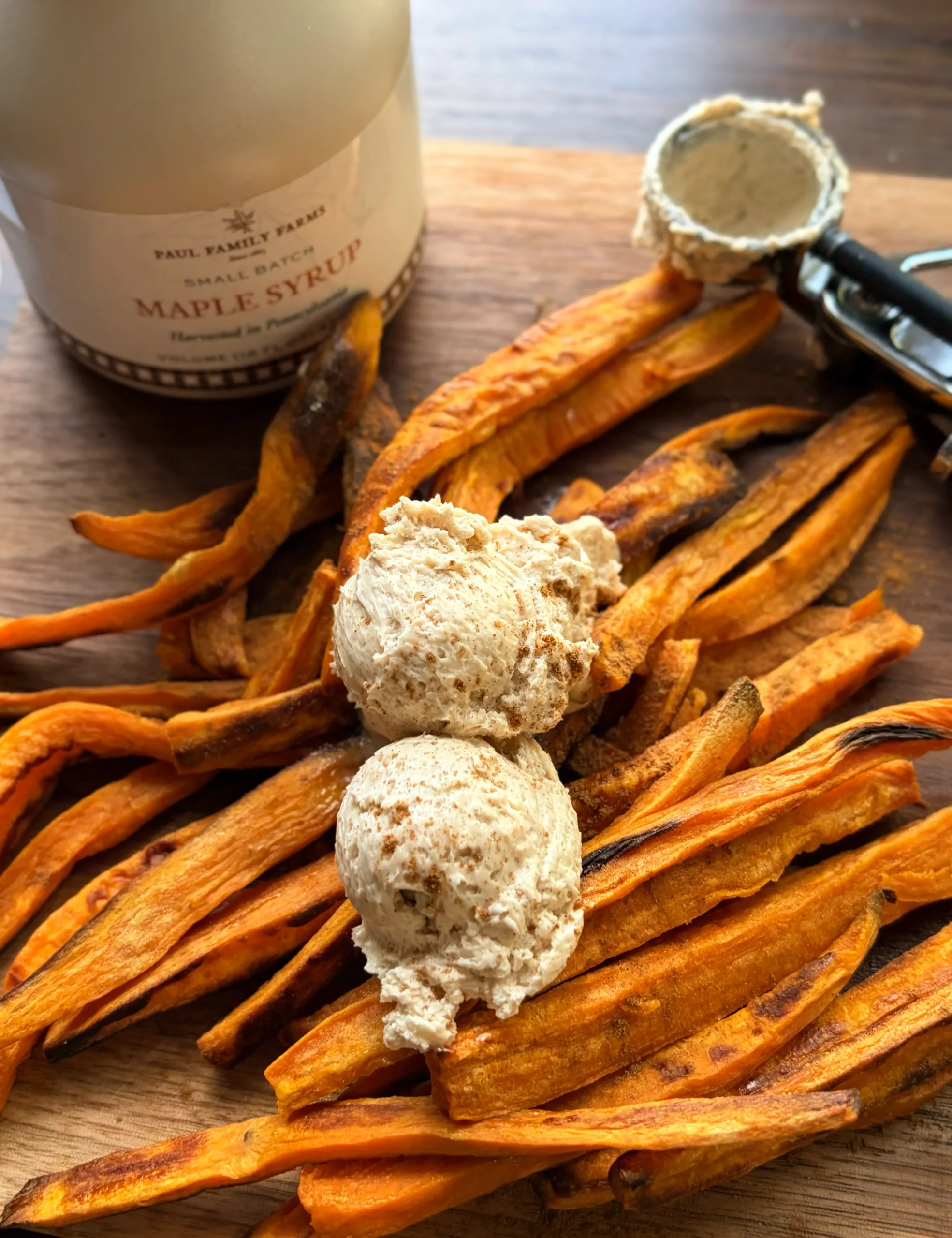 Sweet potato fries with cinnamon maple butter scooped on top.
