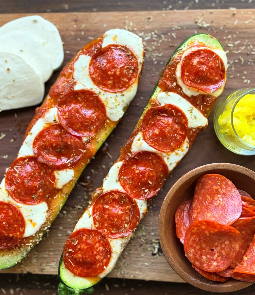 Two zucchini pizzas with mozzarella cheese and pepperoni on the side.