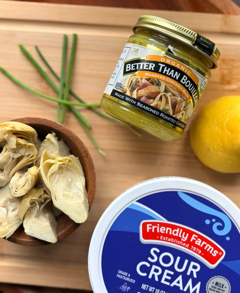 Ingredients for creamy artichoke chicken, sour cream, artichokes, chicken boullion.