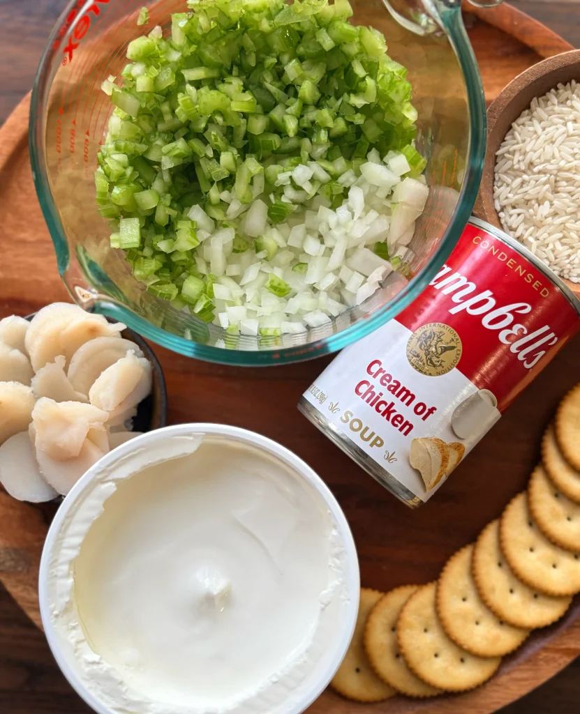 Sour cream, cream of chicken casserole, diced onion and celery, ingredients for chicken casserole.